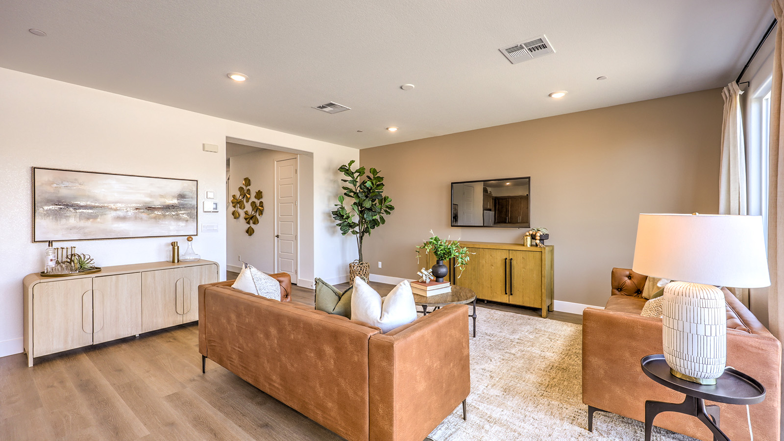 The Serenity 2660 Plan open concept Great Room with ceramic tile flooring, large windows, and a sliding door to the backyard.