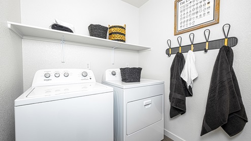 Laundry room with shelf above washer adn dry