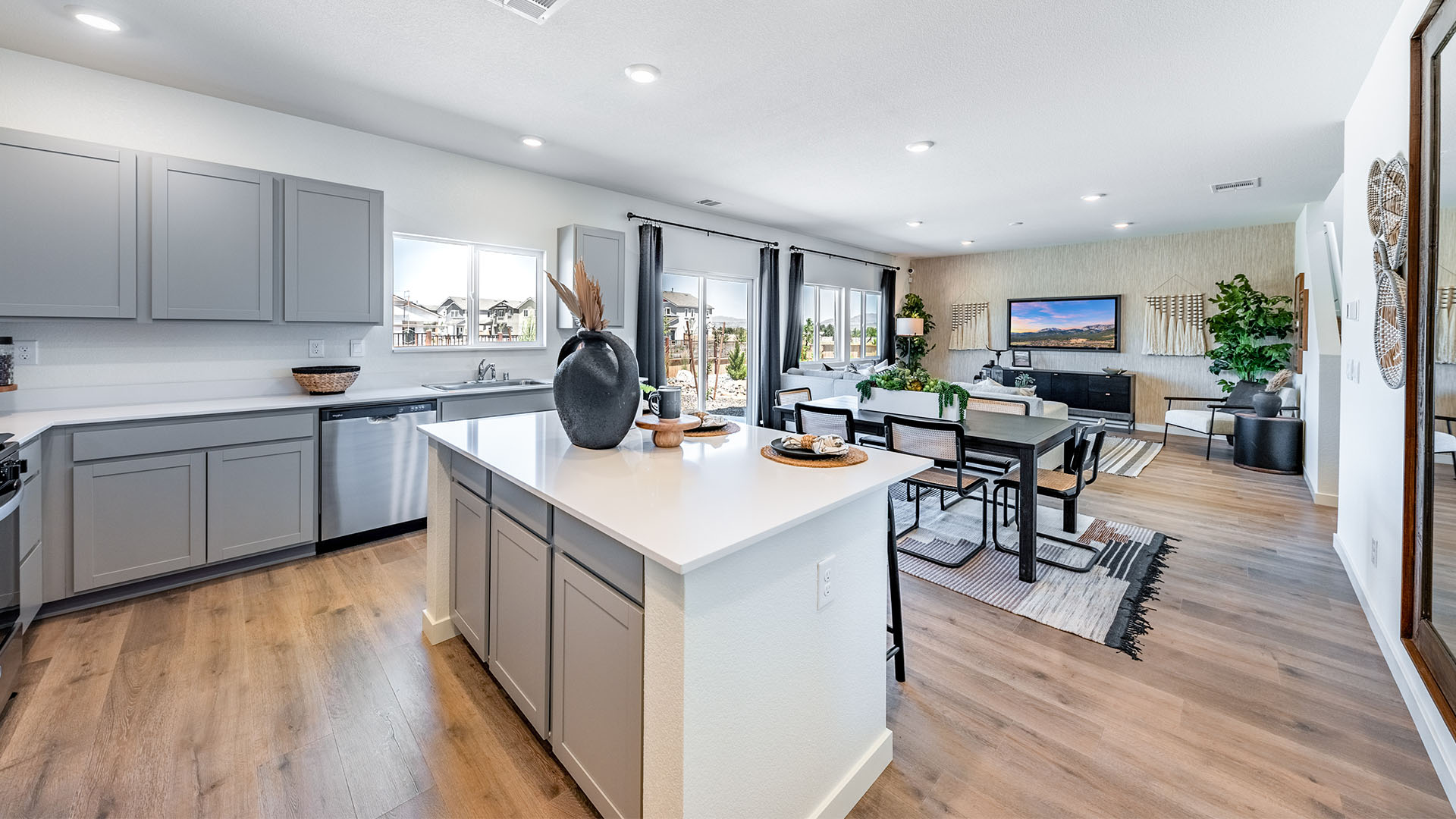 Open concept kitchen and living room space with large windows