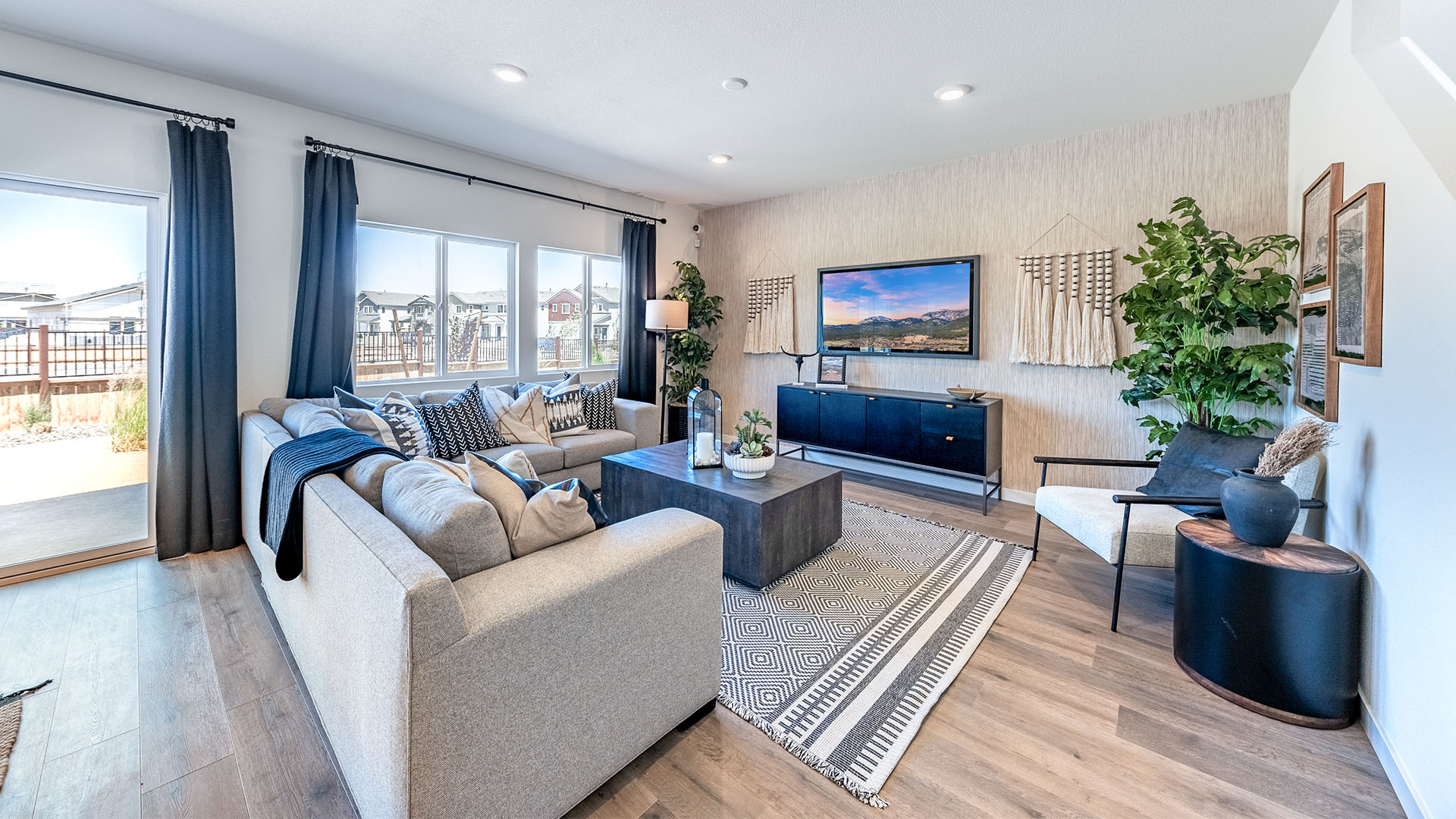 Living room with large windows looking out onto back yard