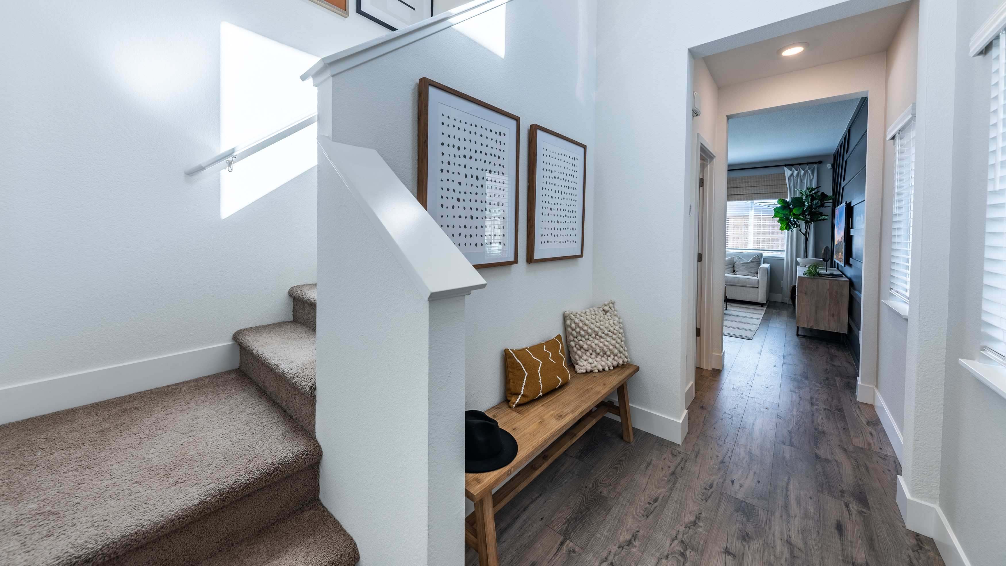 Home entry leading to first floor open concept and staircase at the front of the home