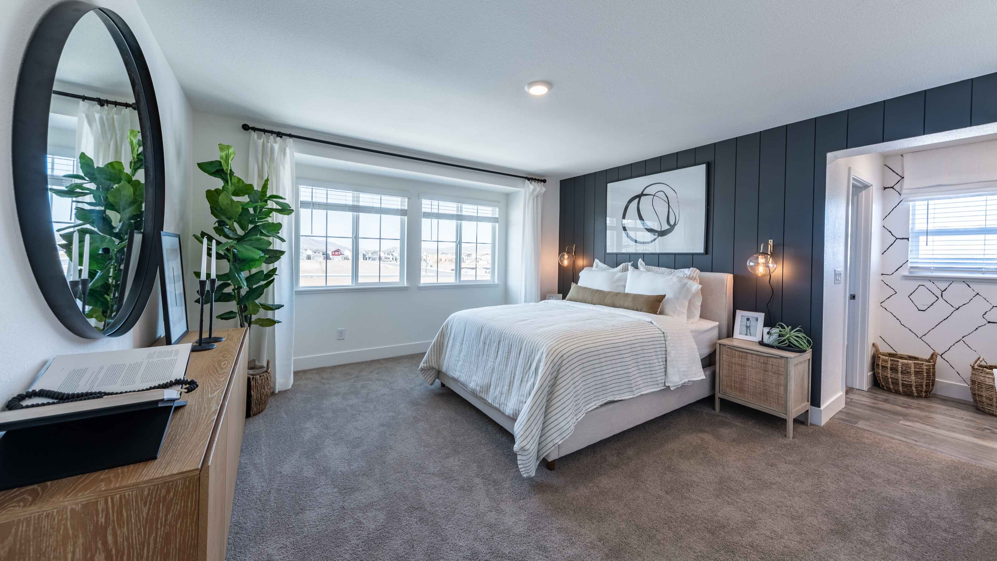 Primary bedroom with cozy carpeted floor, large windows, and an attached bathroom