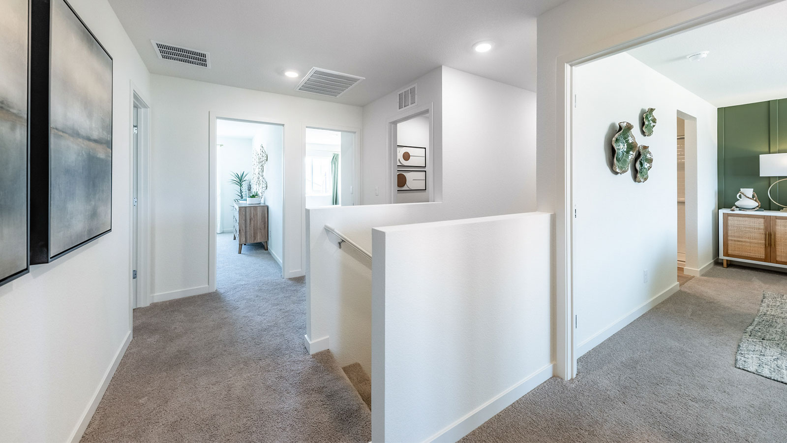 Carpeted second floor hallway leading to the four bedrooms upstairs