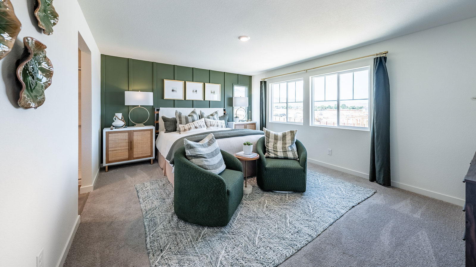 Large primary bedroom with carpet and large windows