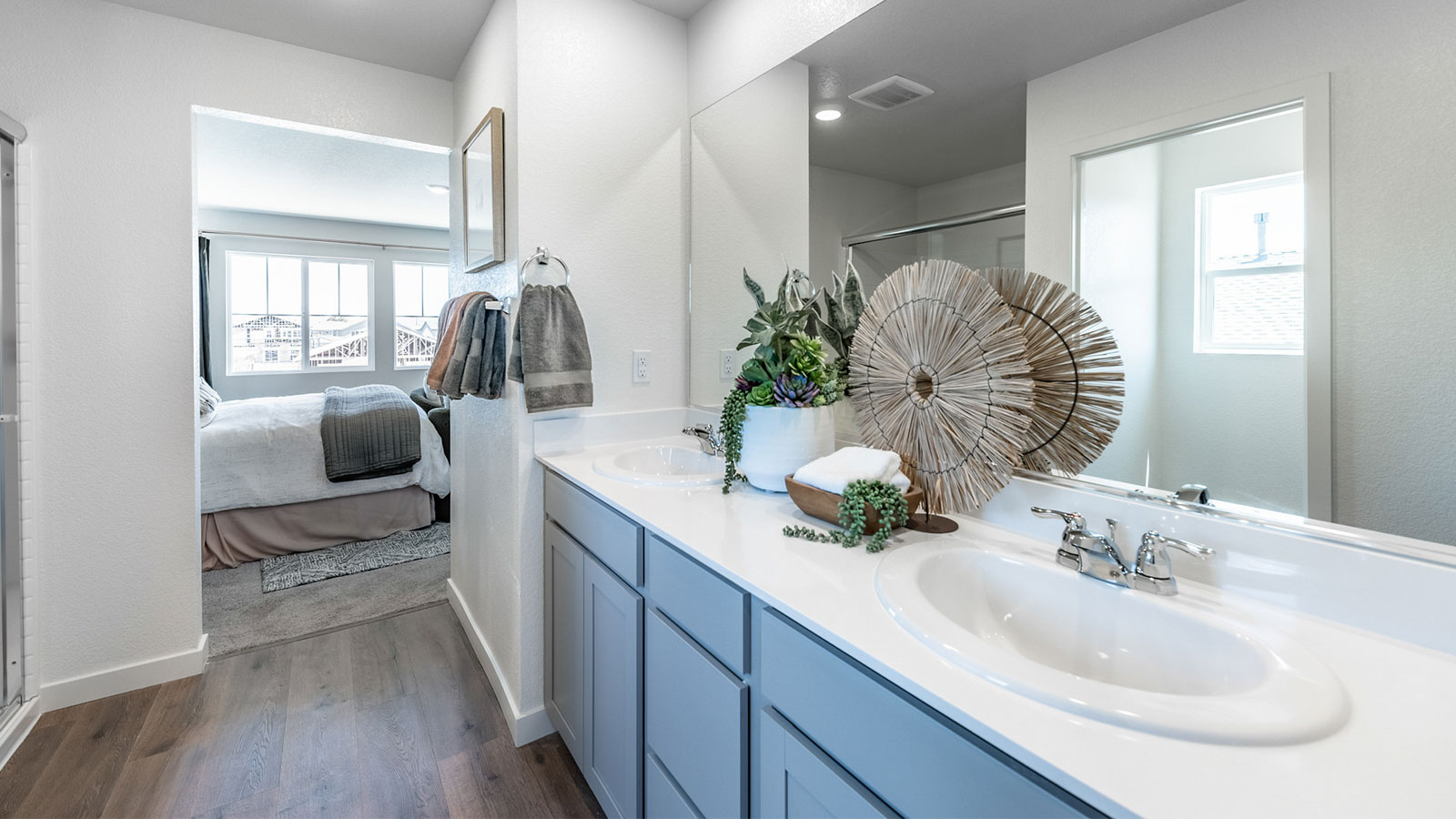Primary bathroom with double vanity and large mirror