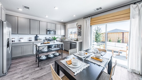 Kitchen and dining area next to back patio door