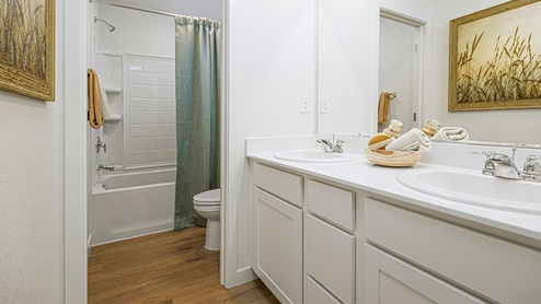 Secondary bathroom with separate bathtub and toilet