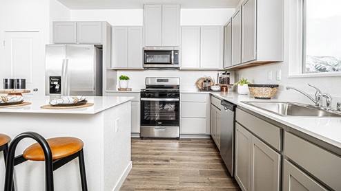 Grey cabinets with stainless steel appliances
