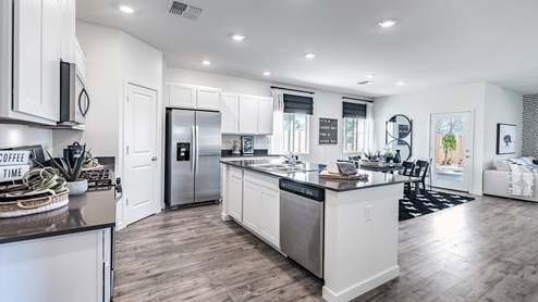 Kitchen with white cabinets, stainless steel appliances and island