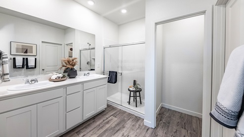 Bathroom with shower and white cabinets