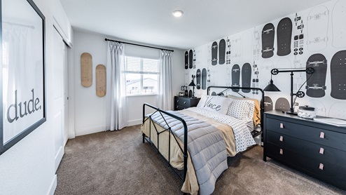 Secondary bedroom with large window decorated for teen