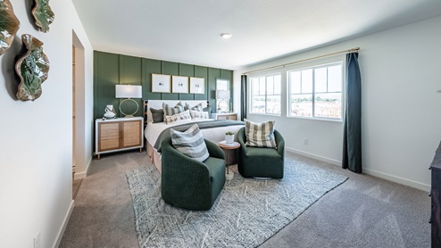 Primary bedroom with large windows and carpet