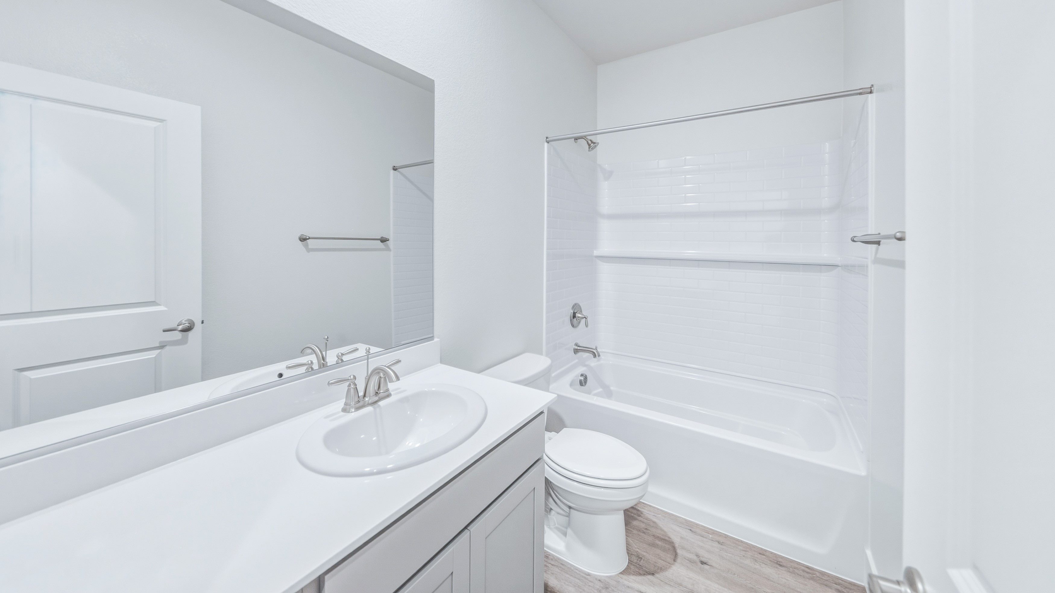 Secondary bathroom with a single sink, toilet, and tub/shower combination