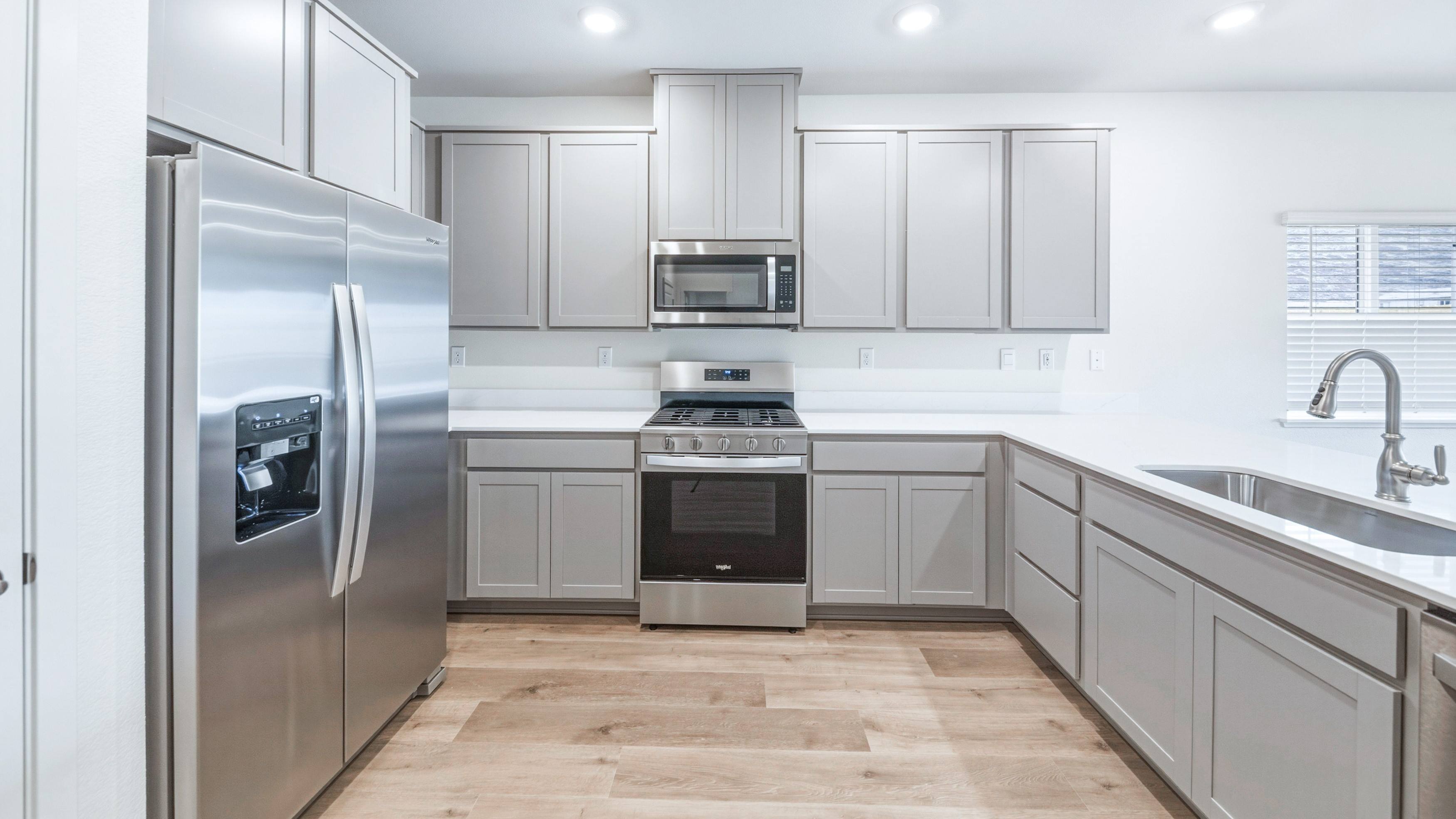 Kitchen with L-shaped island and stainless steel appliances
