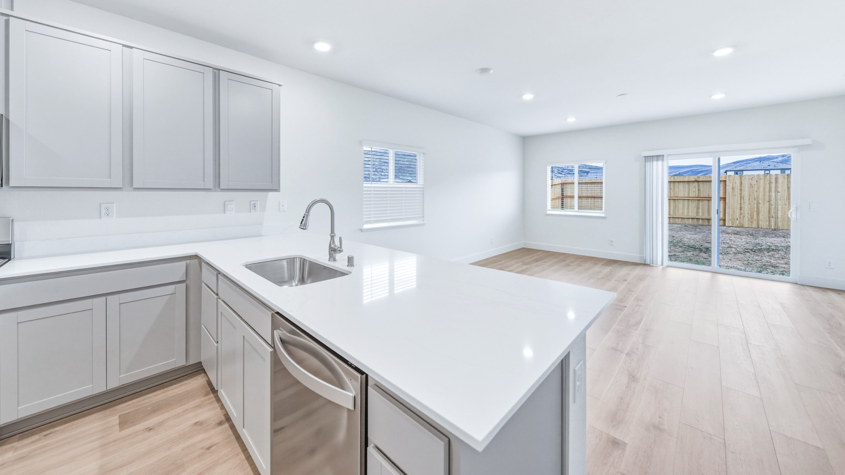 L-shaped island with dishwasher and single basin sink