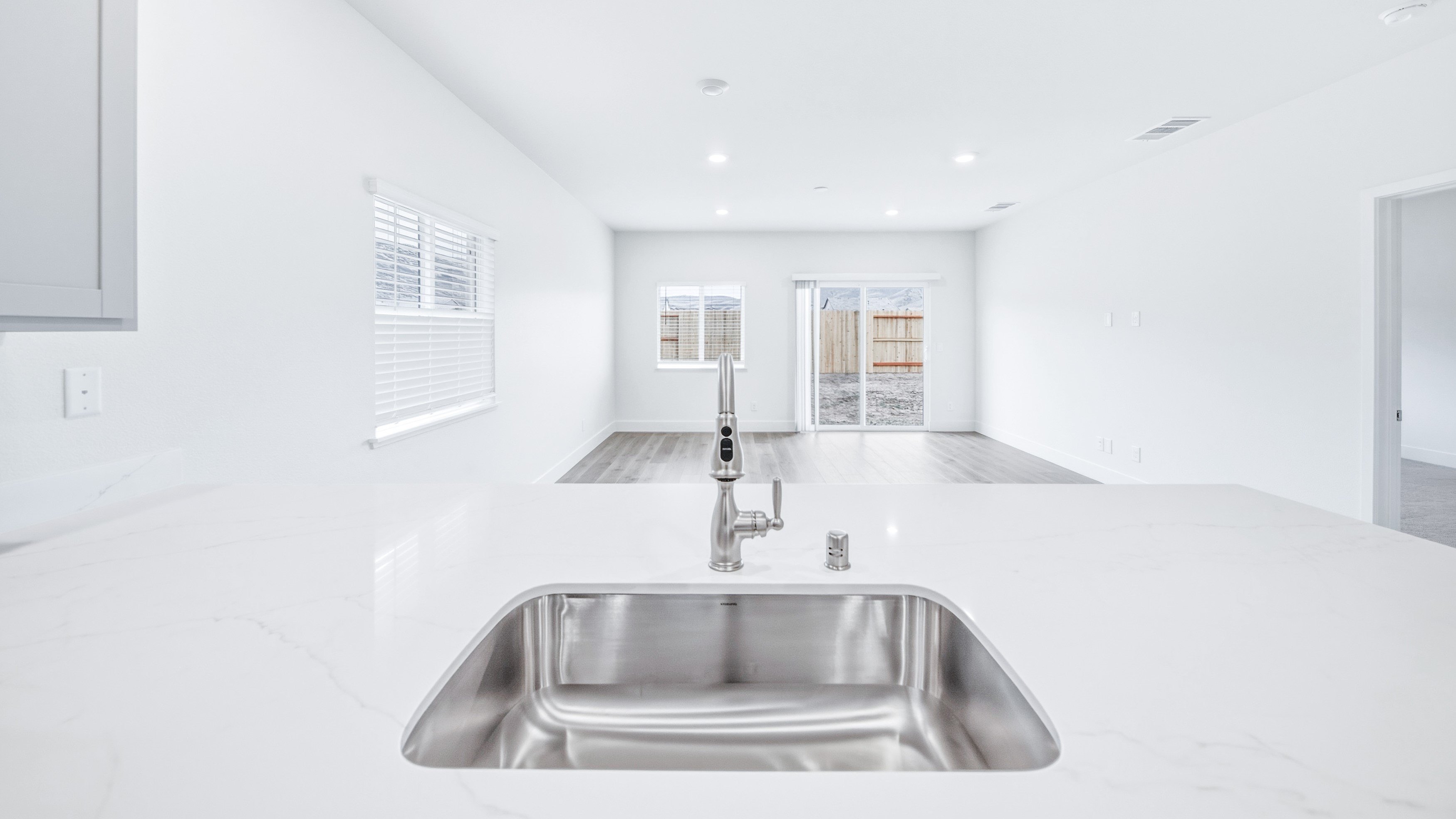 Island looking out towards the great room with single basin sink