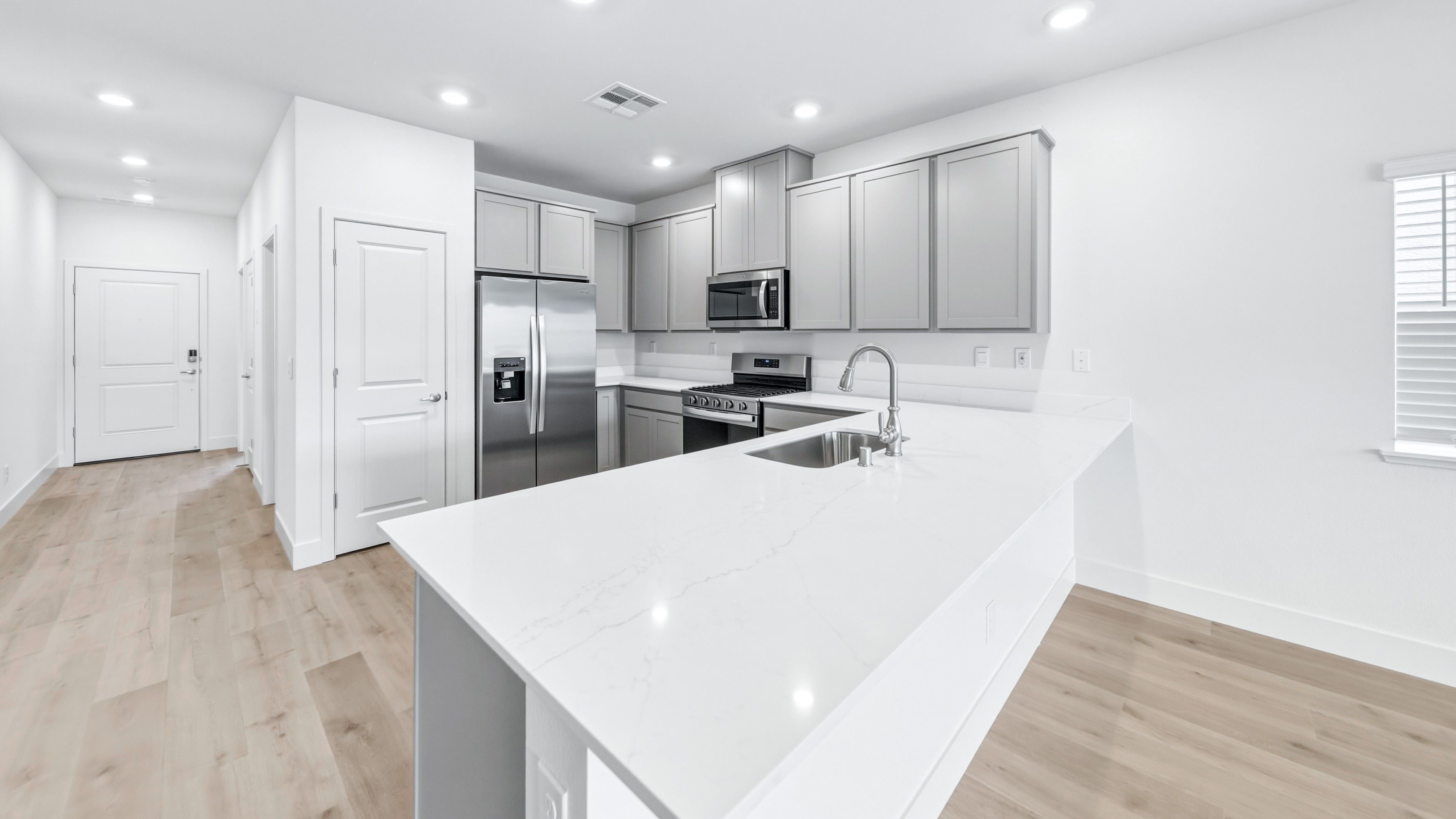 L-shaped island and stainless steel refrigerator