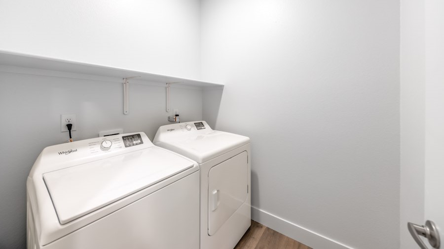 Separate laundry room with space for a full sized washer and dryer