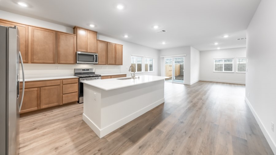 Large kitchen with shaker-style cabinets, an island, and stainless steel appliances