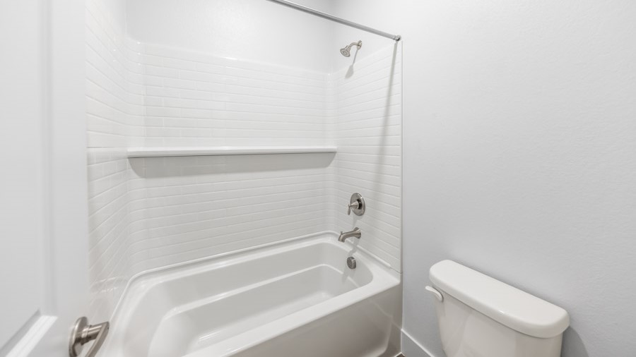 Secondary bathroom with bathtub and shower combo