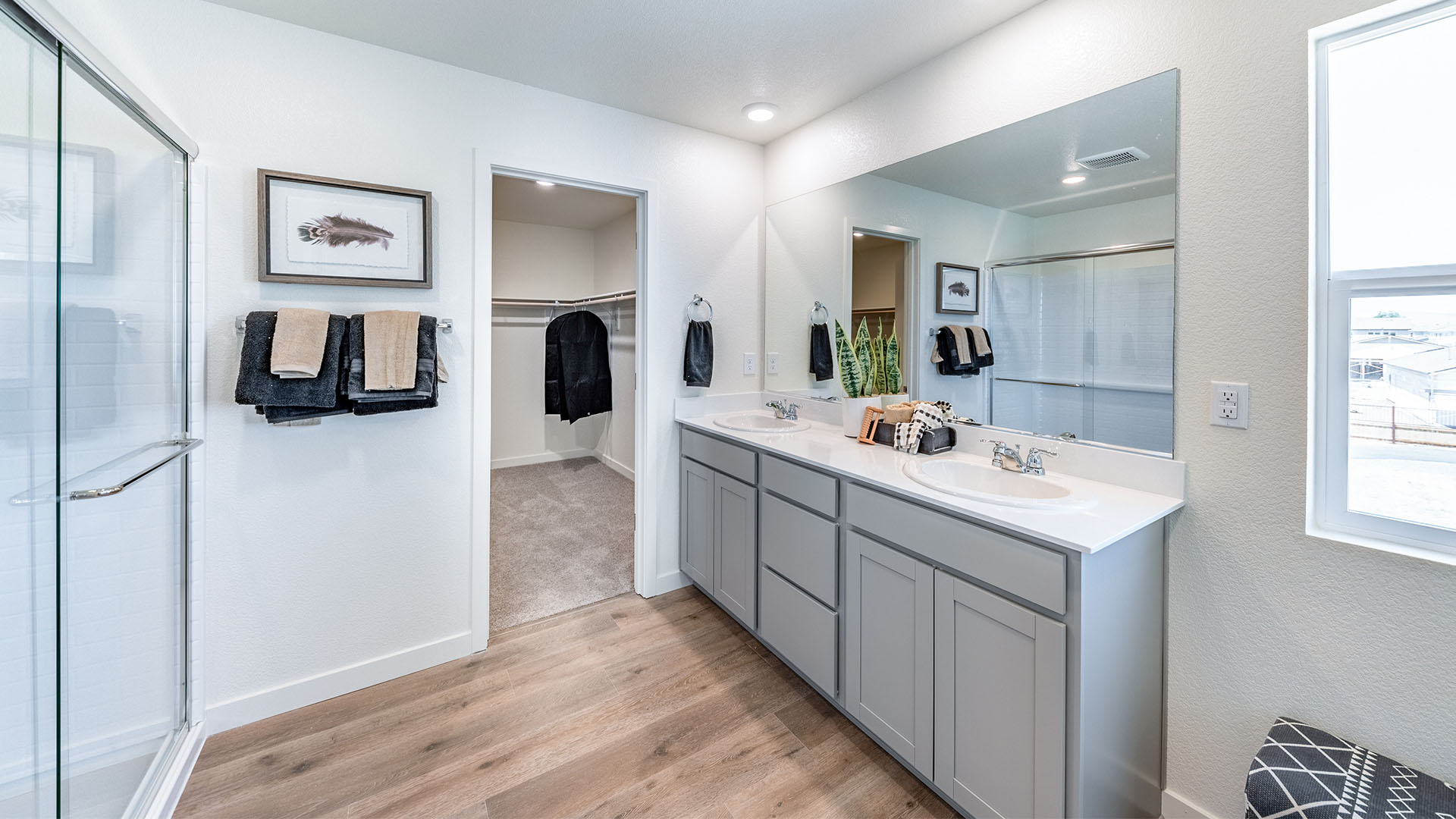Double vanity next to walk-in closet in primary bathroom