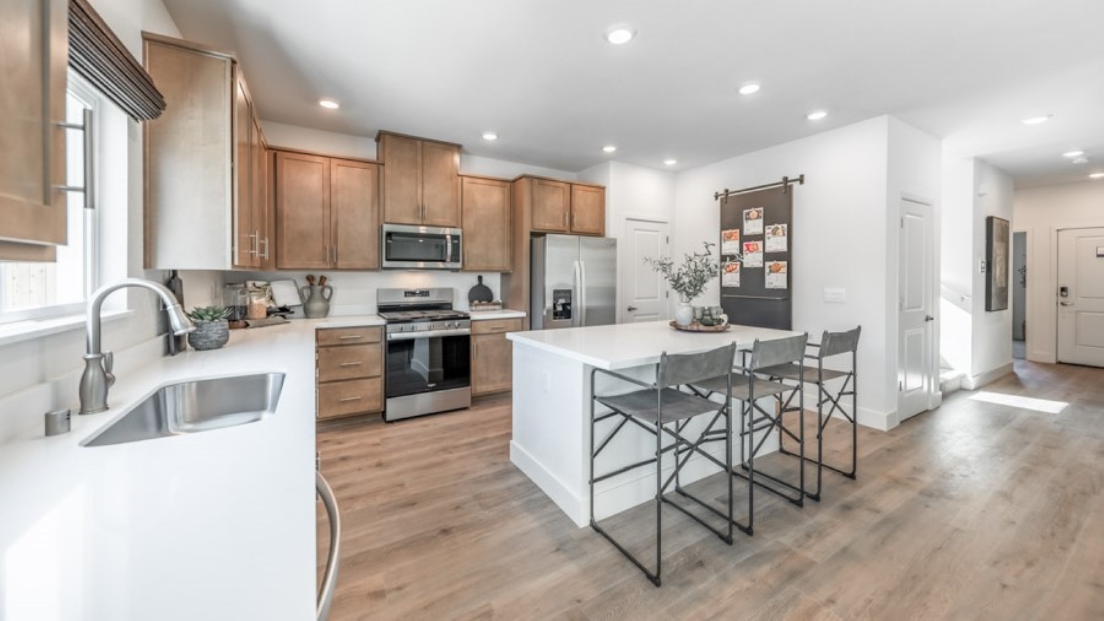 Bright modern kitchen with island and shaker style cabinets