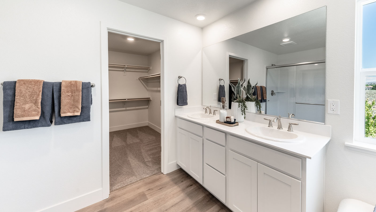 Primary bathroom with double vanity and large closet