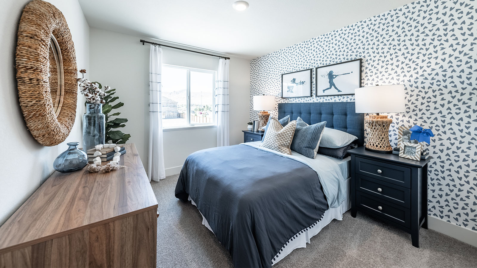 Bedroom decorated for a teen with a large window and carpeted floor