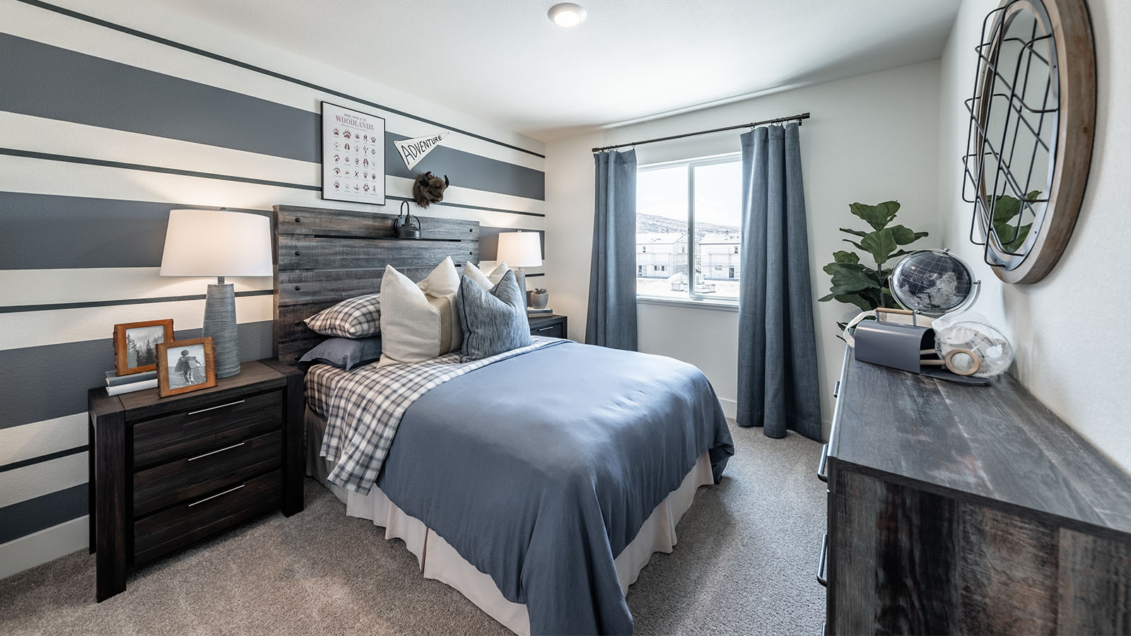 Secondary bedroom with a large window and carpeted floors