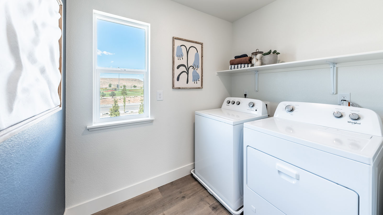 Second floor laundry room with window and plenty of room for a full sized washer and dryer
