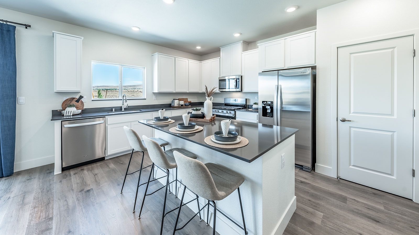 Bright open kitchen with window above the sink and an island