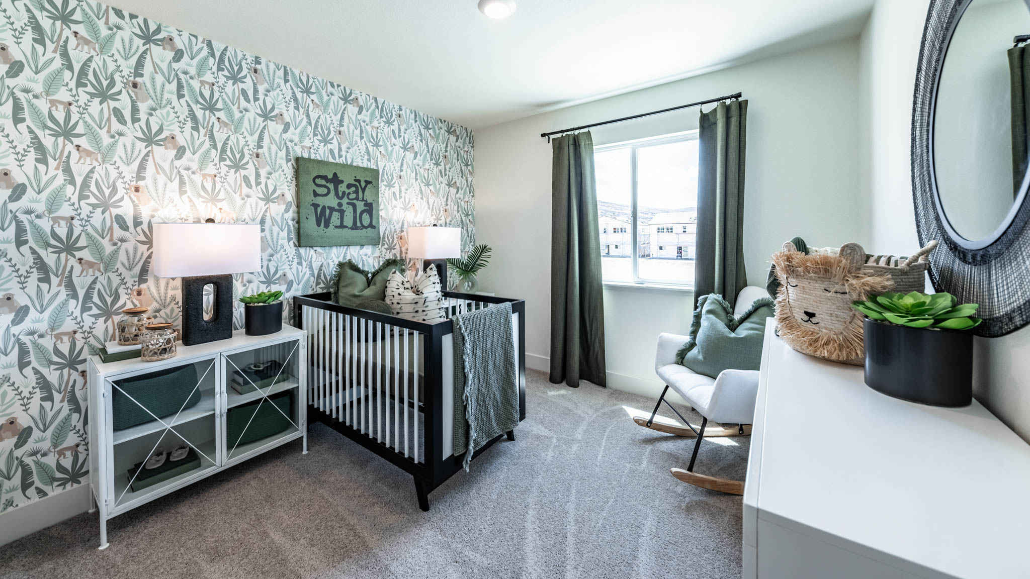 Nursery with carpet and large window letting in bright light