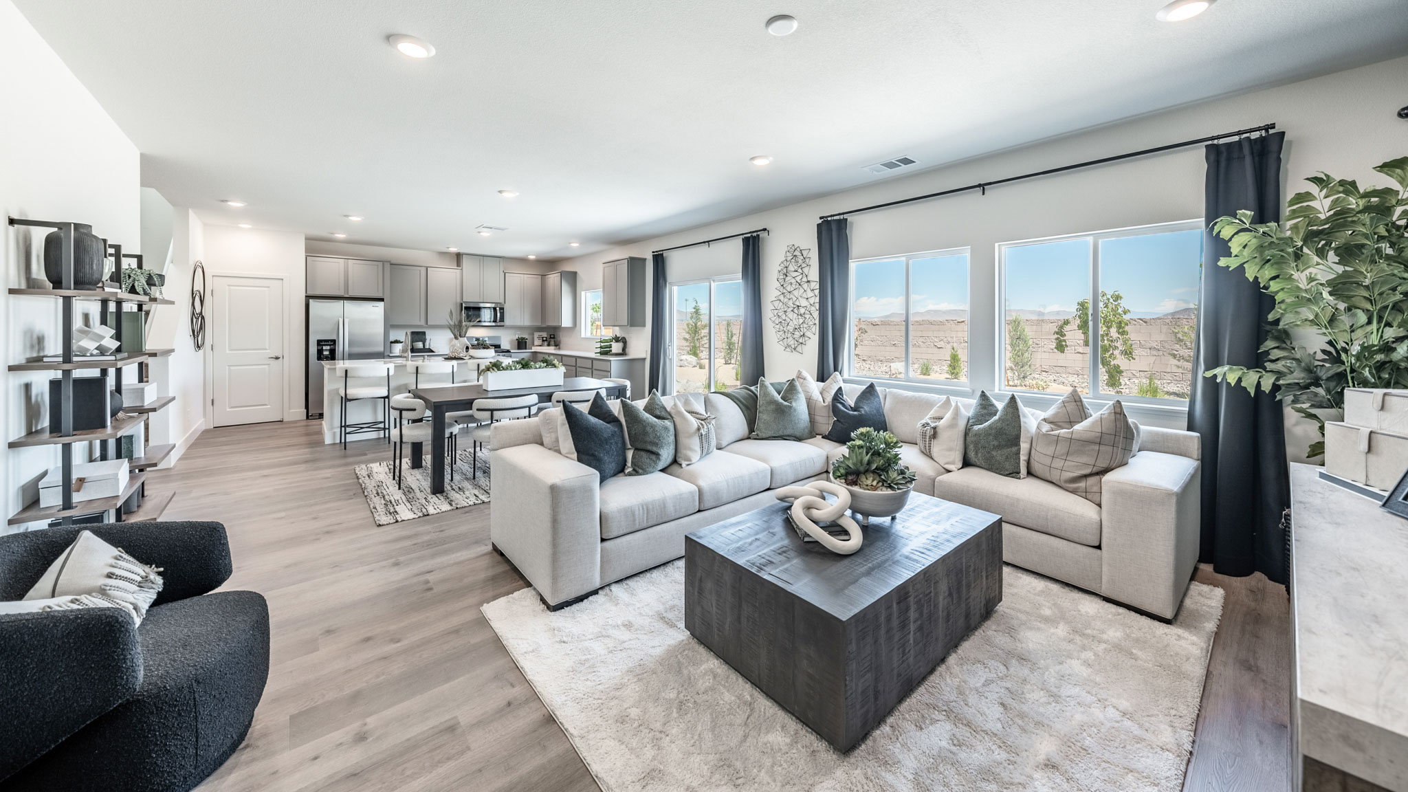 Living room with space for a large sectional couch and large bright windows