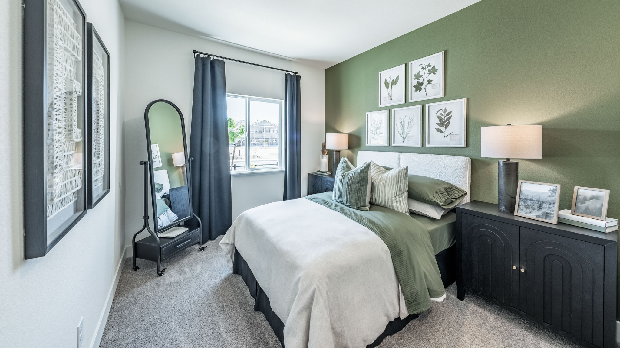 Bedroom on the first floor on the home with large window letting in natural light