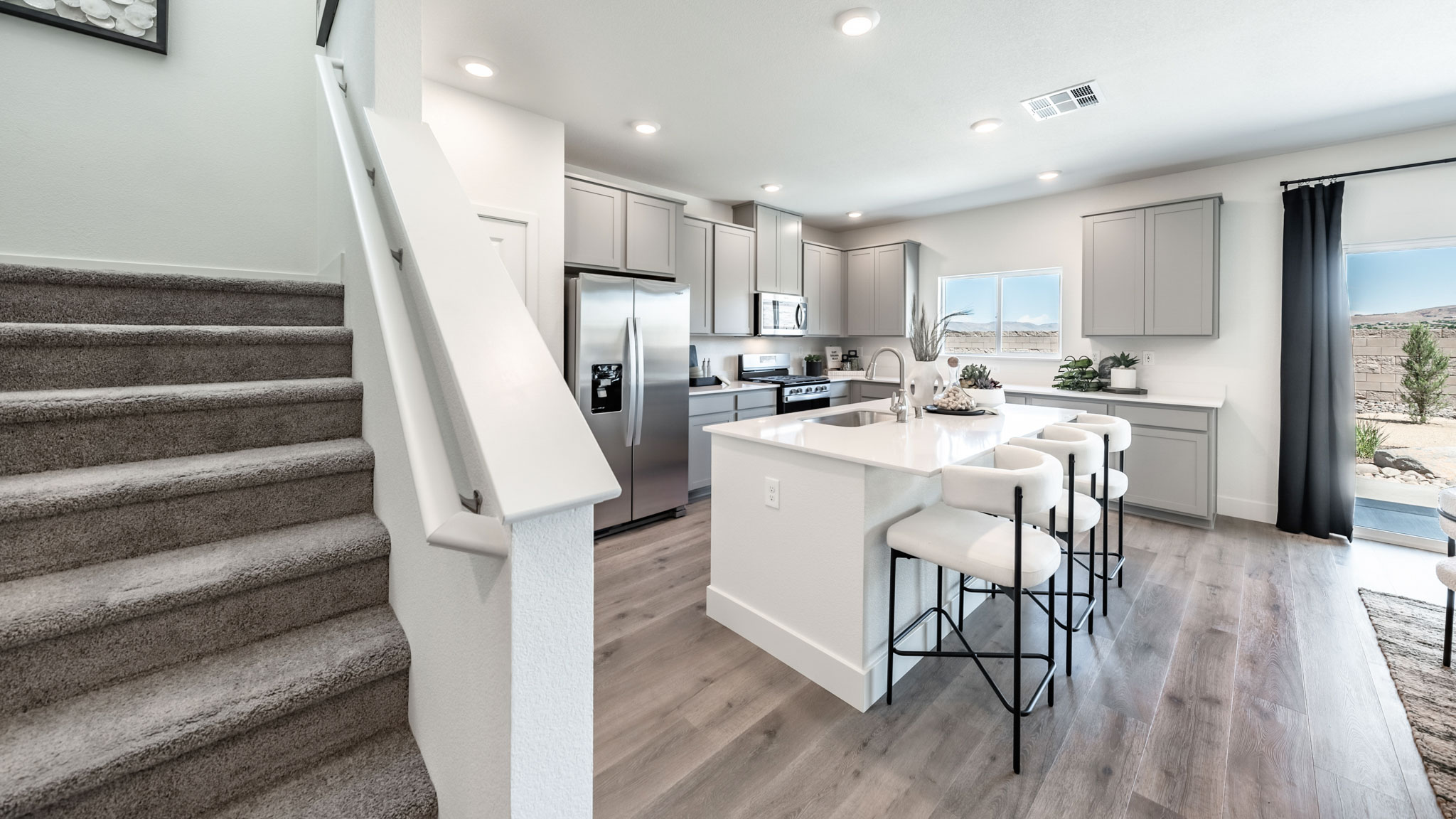 Kitchen next to staircase to second floor