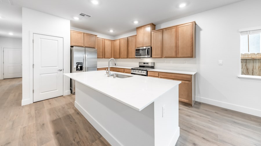 Modern shaker-style cabinets and stainless steel appliances