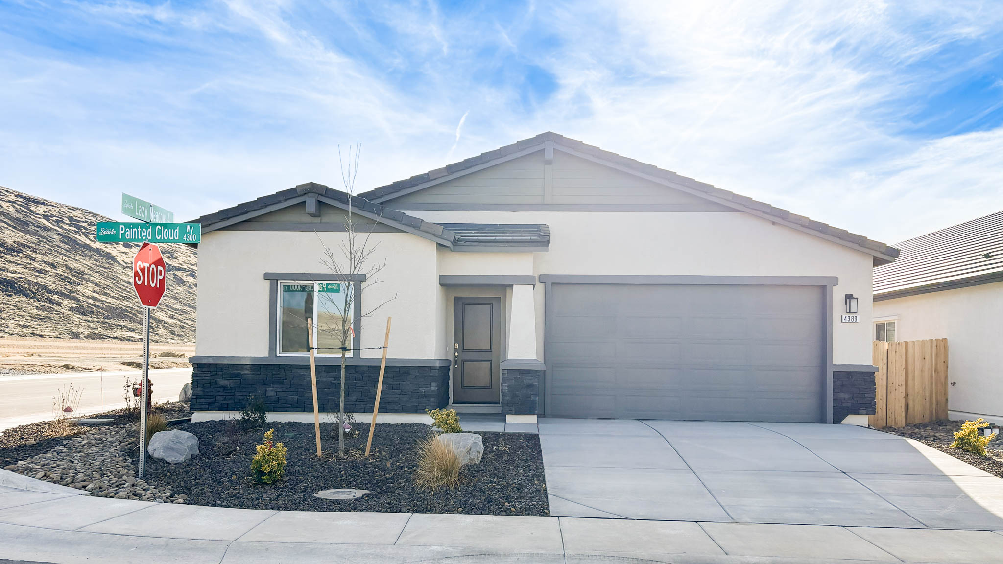 Single-story Donner rendered with stucco and stone