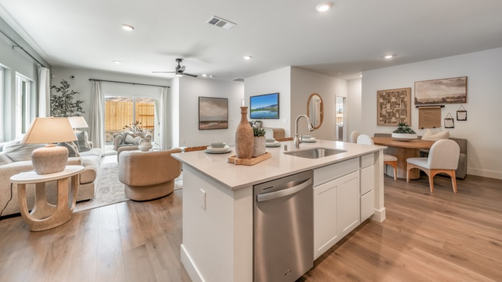 Spacious kitchen featuring an island with built-in dishwasher and sink