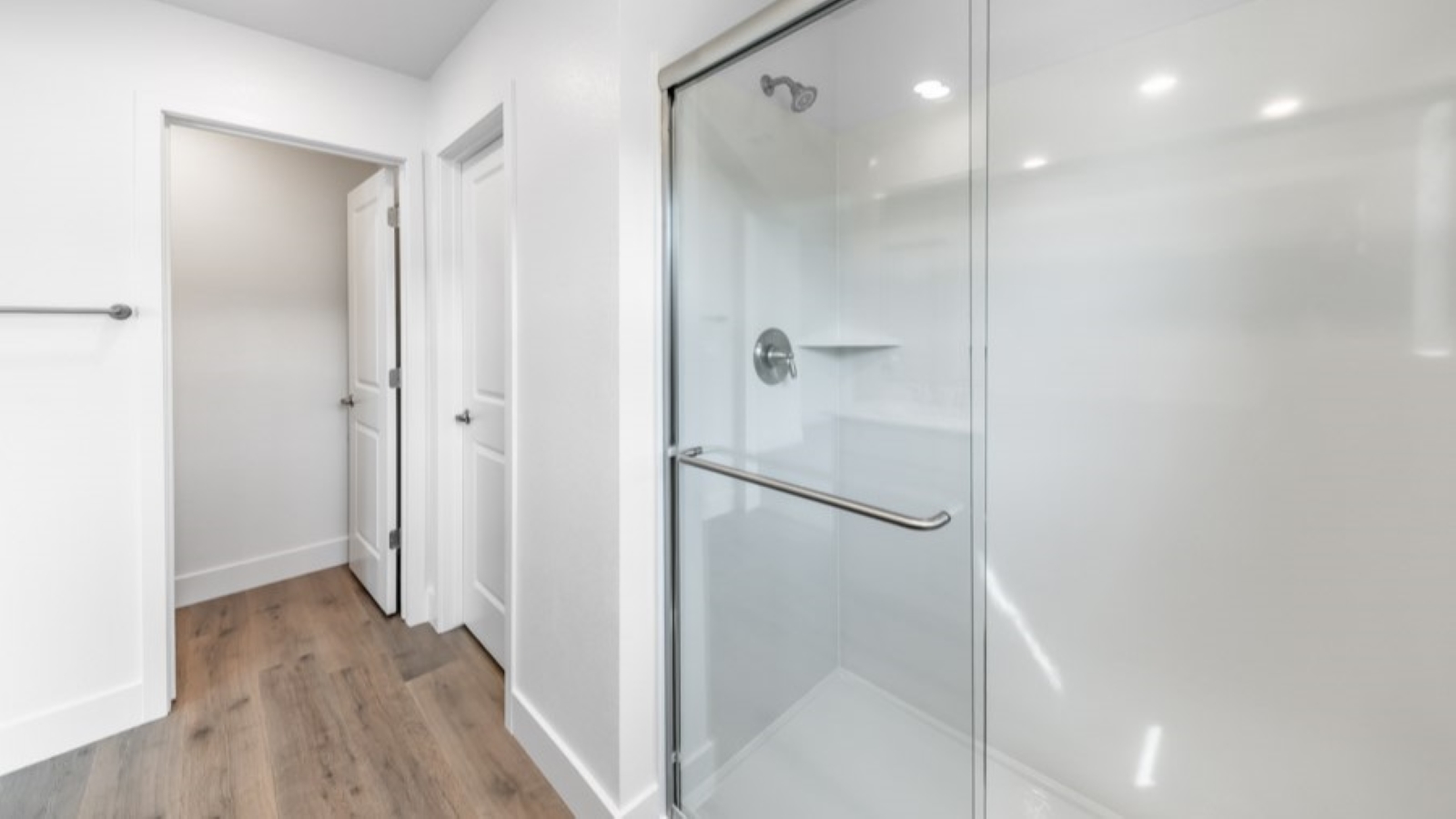 Large primary bathroom with walk-in shower and large walk-in closet