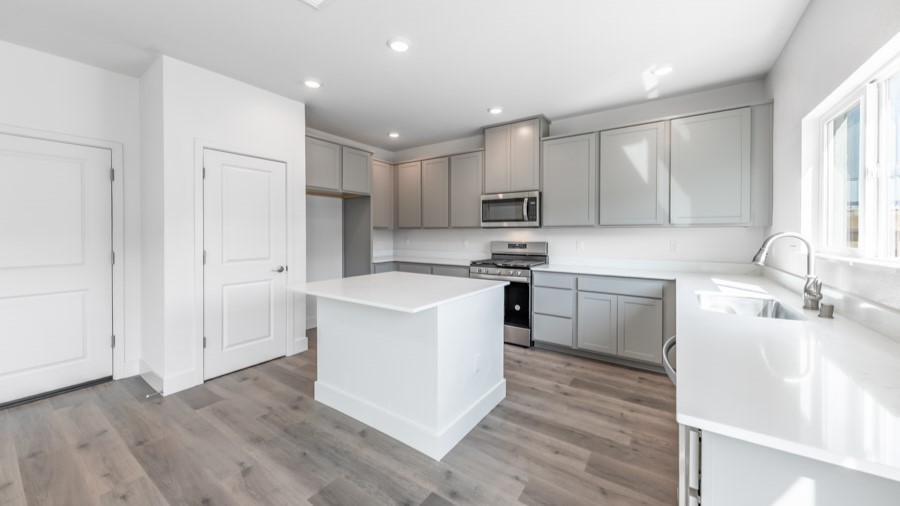 Bright modern kitchen with island with window above the sink