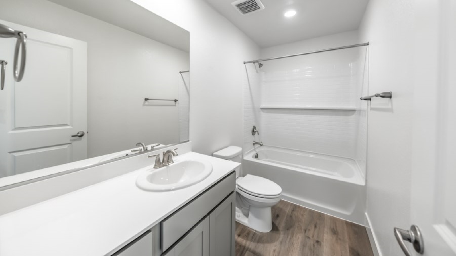 Secondary bathroom with separate room for toilet and bathtub and shower combo