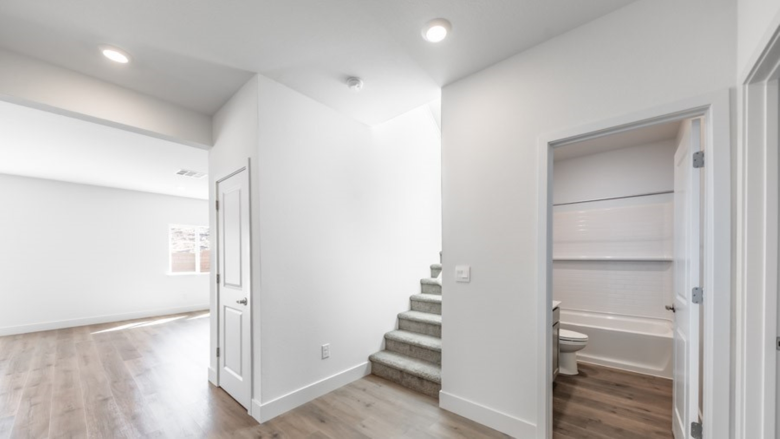 Entry to the Stampedefloorplan with a bedroom and bathroom at the front of the home