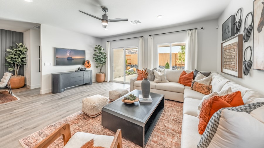 Living room with space for a large sectional couch and large bright windows
