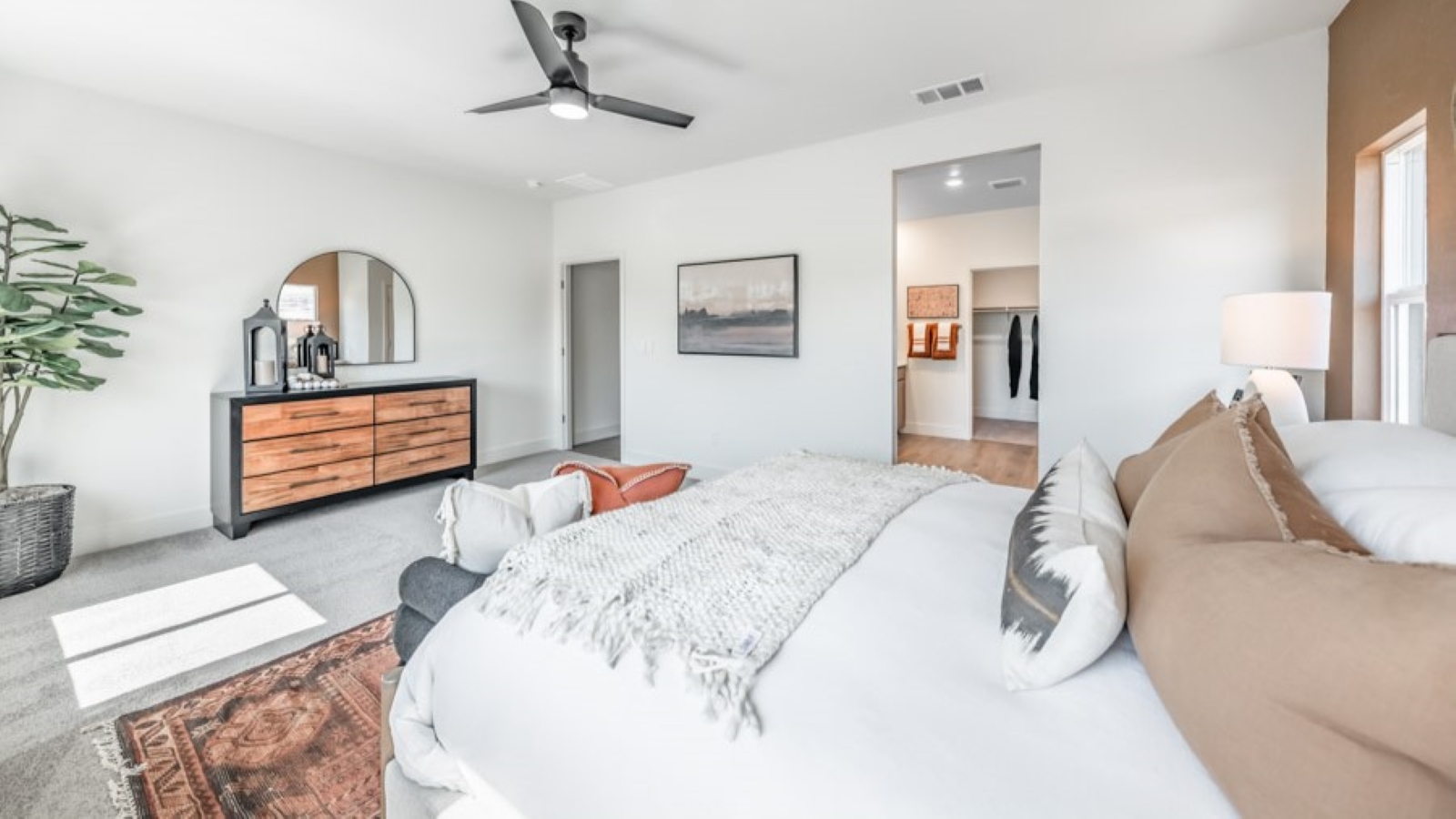 Bright primary bedroom with room for a large bed looking towards the bathroom