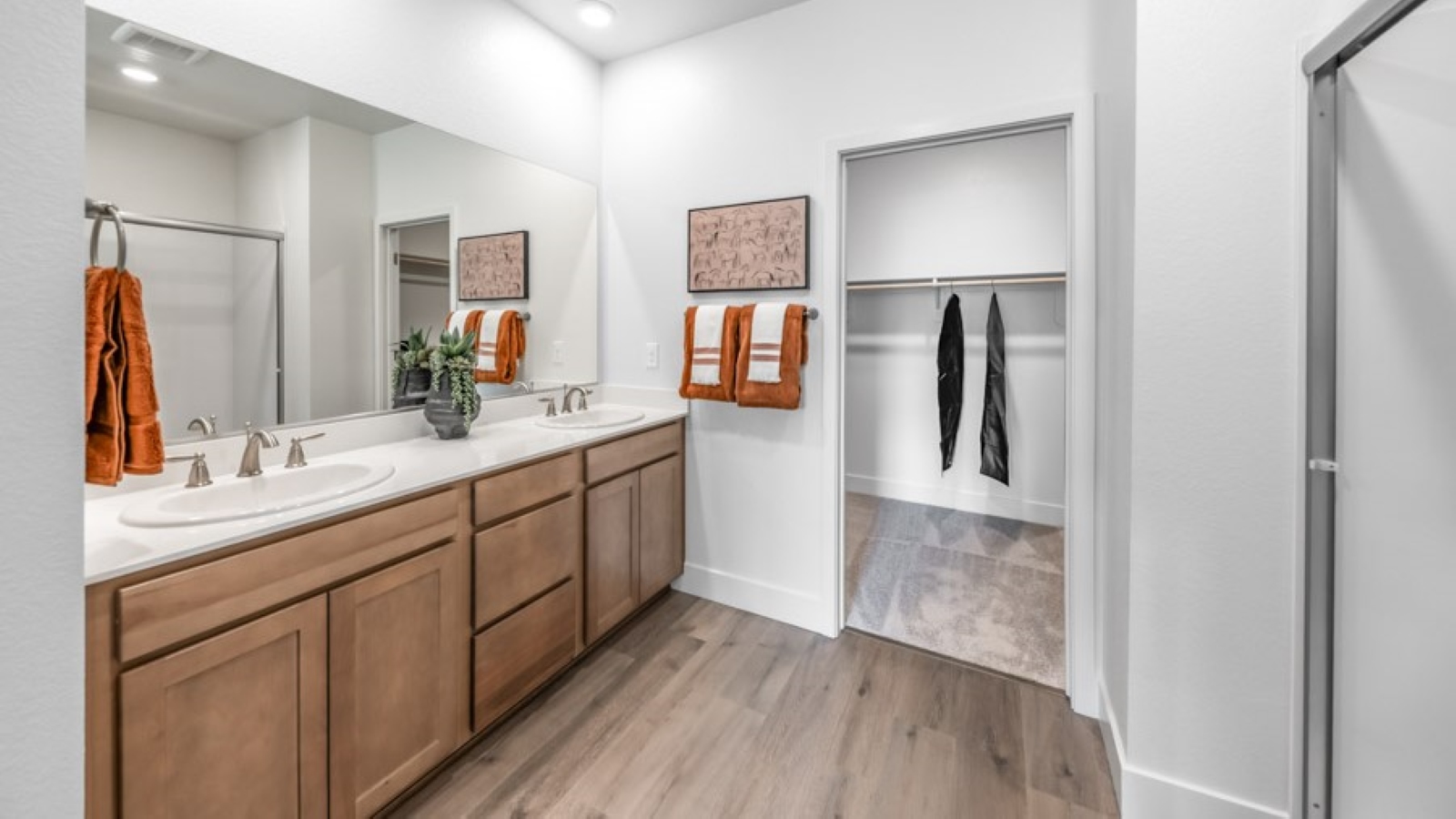 Large primary bathroom with walk-in shower and large walk-in closet