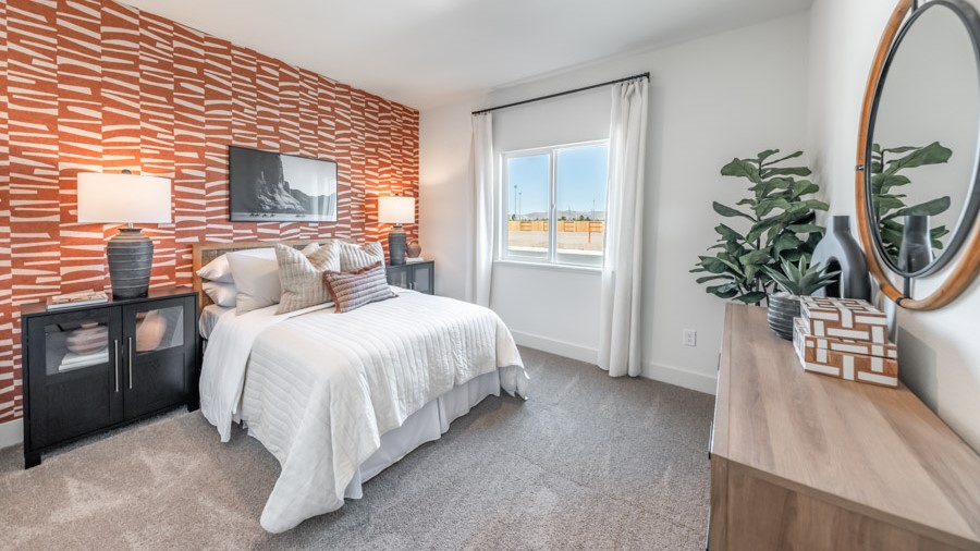 Bedroom on the first floor on the home with large window letting in natural light