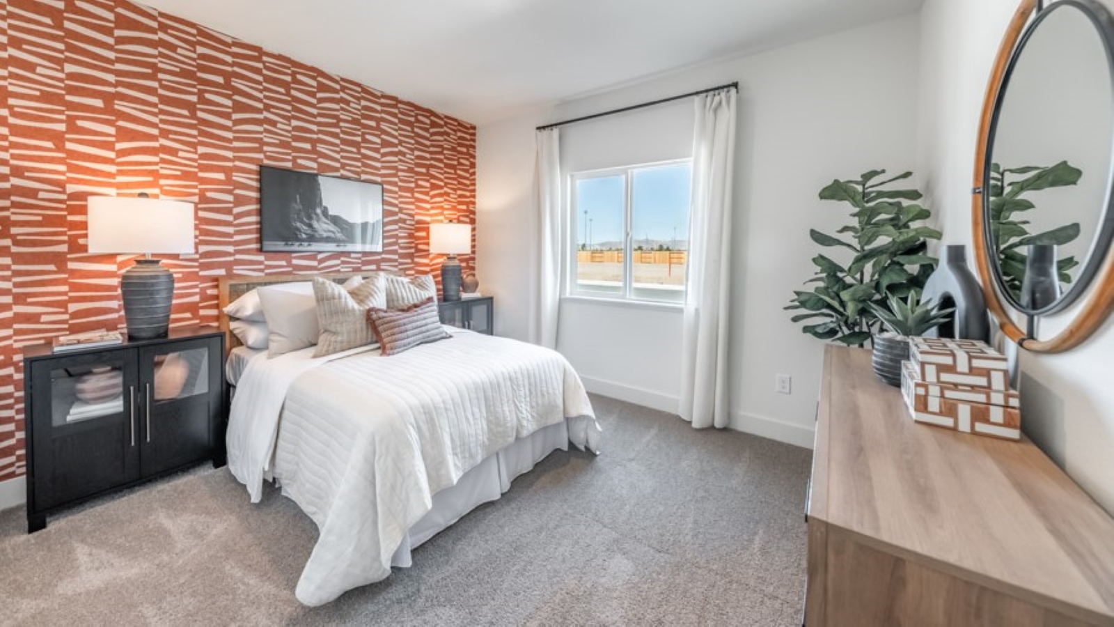 Bedroom on the first floor on the home with large window letting in natural light