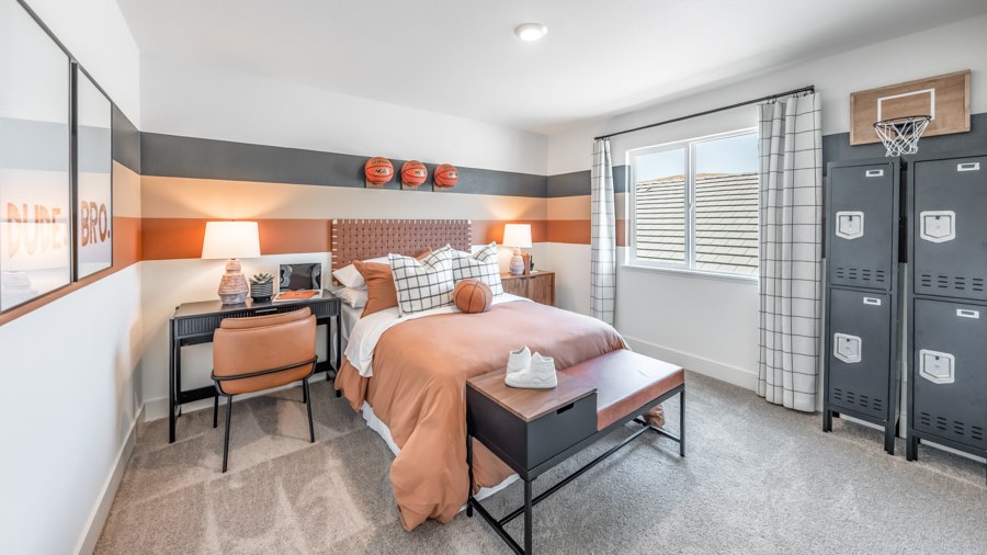 Kid's bedroom with carpet and large window letting in bright light
