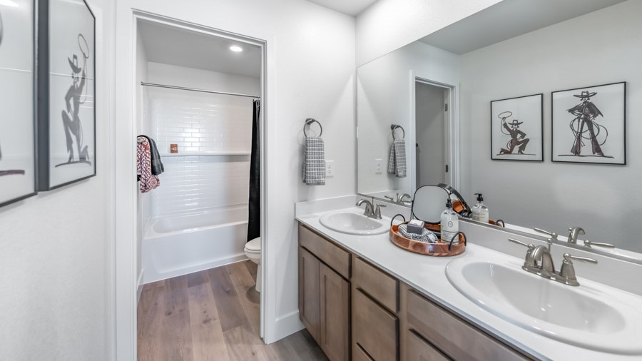Secondary bathroom with separate room for toilet and bathtub and shower combo