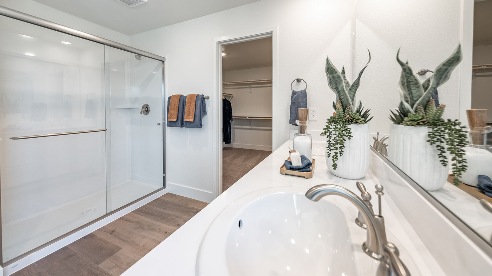 Walk-in shower in primary bathroom with double vanity